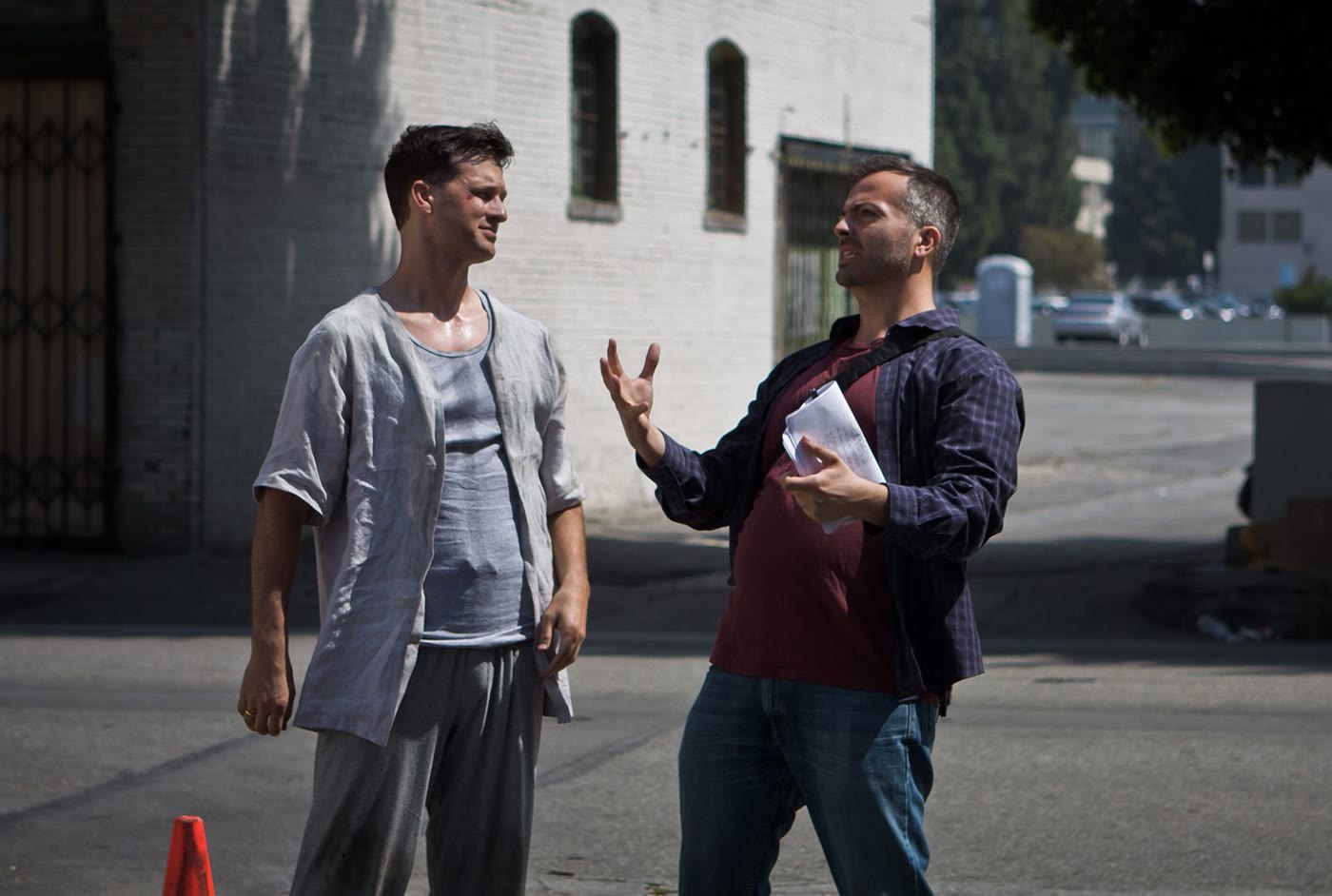 Efram Potelle directing an actor on a downtown street.