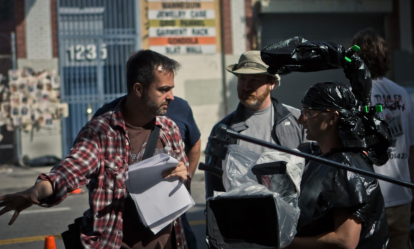 Efram Potelle directing on the street, pages in hand.
