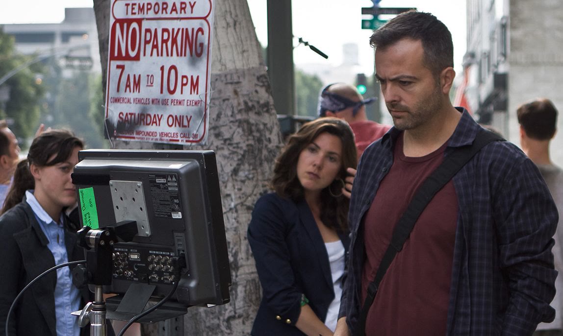 Efram Potelle with the crew at the camera on a downtown street.