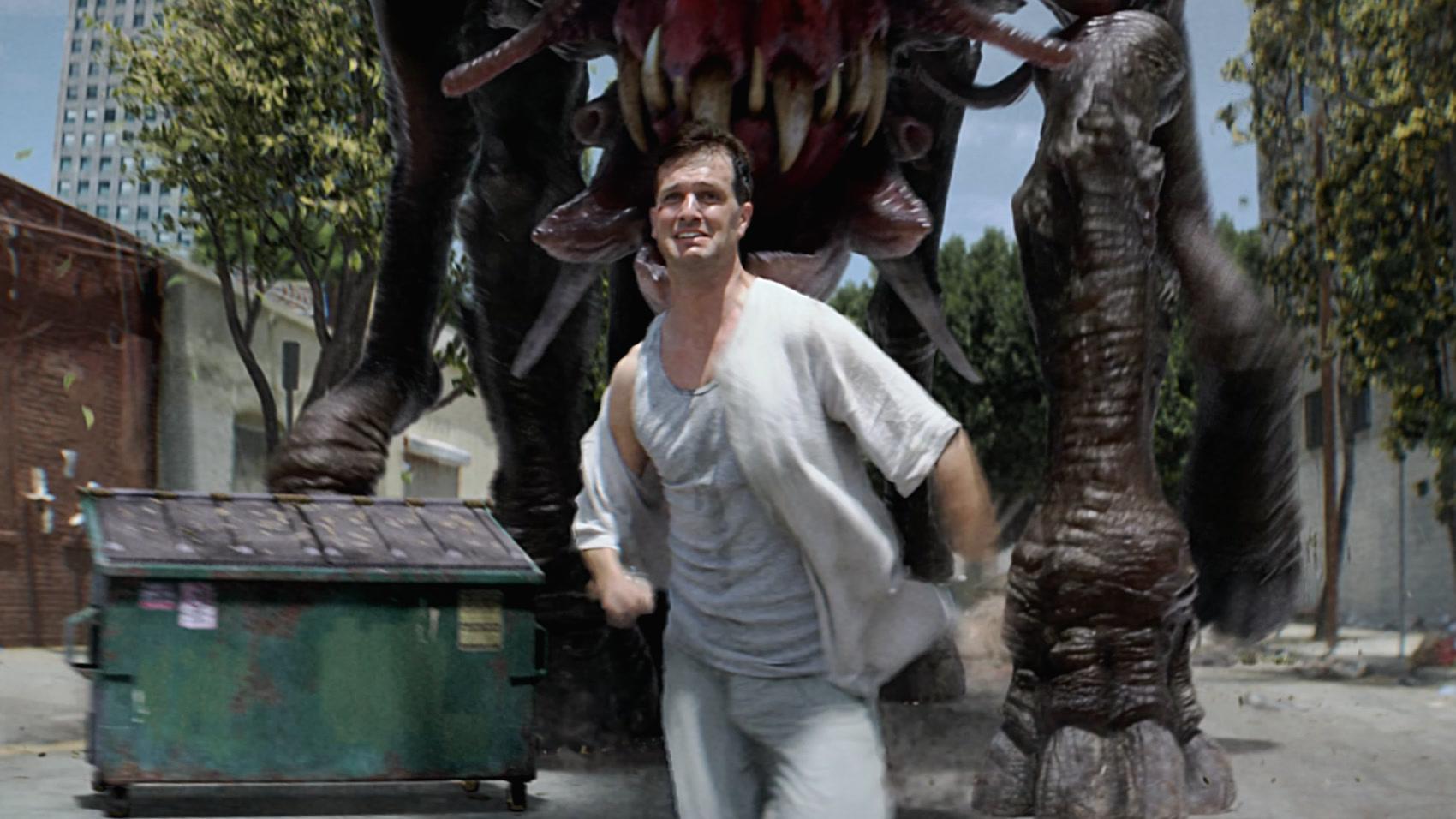 A man running down a ruined street as an enormous creature looms over him — a frame from Endangered.