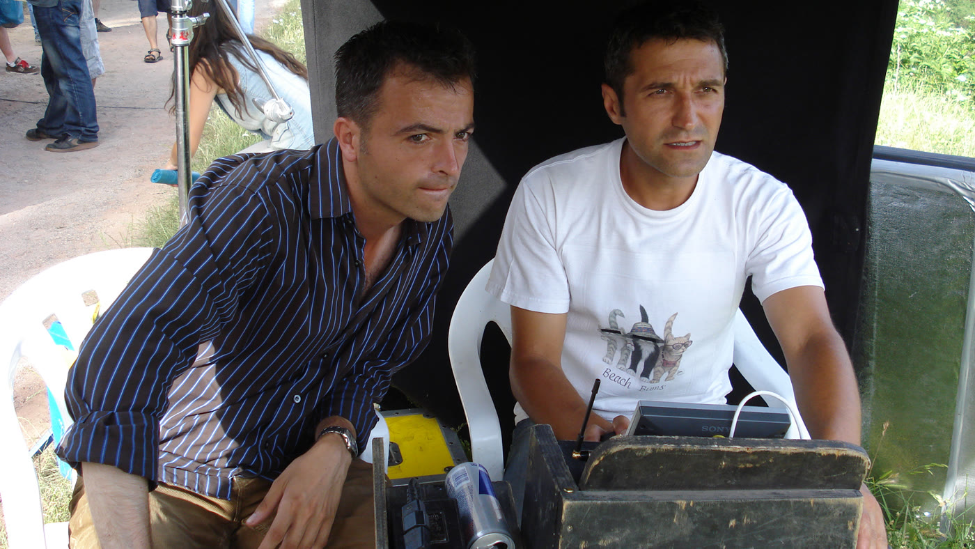 Two crew members watching a monitor on location.